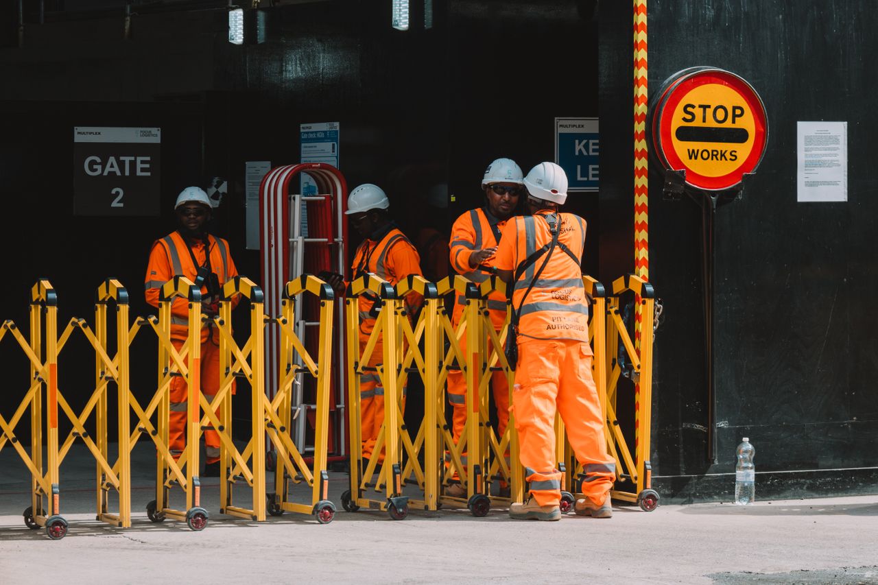 About Group of construction workers in safety gear managing a site in London.