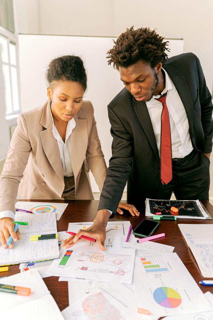 Offerings A professional team working together on business documents in an office setting.