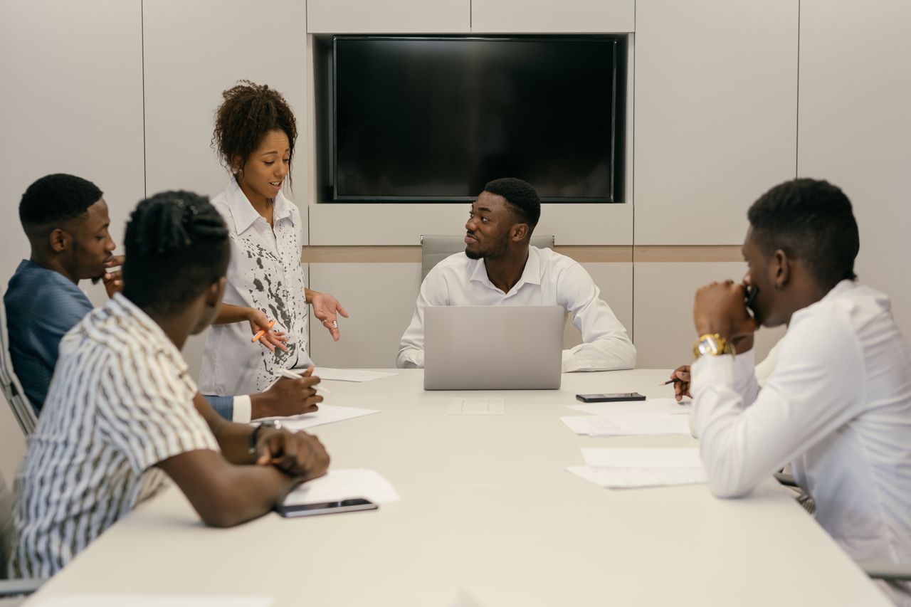 A diverse team of professionals collaborating in a modern office meeting environment.